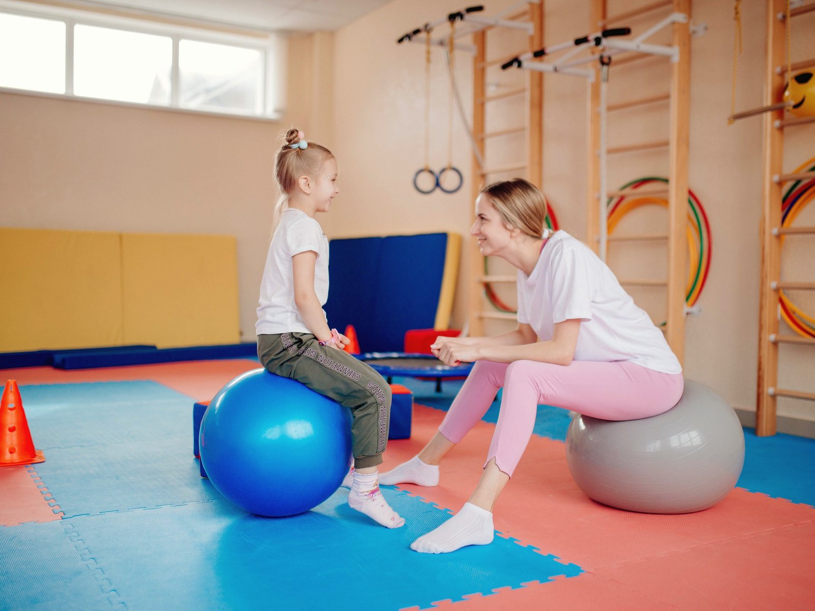 A therapist and a young girl playing together during a therapy session